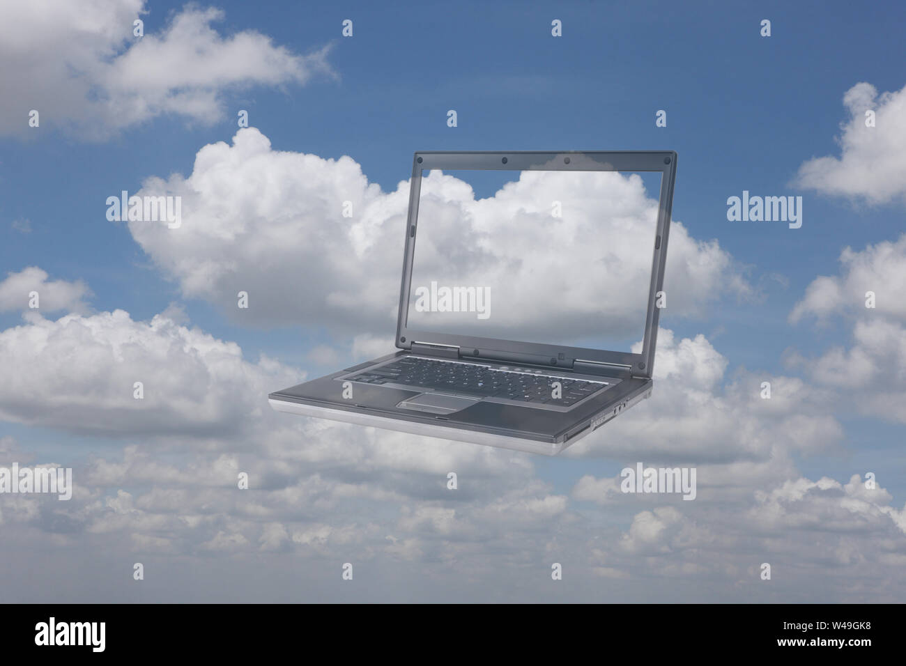 Laptop floating in clouds Stock Photo