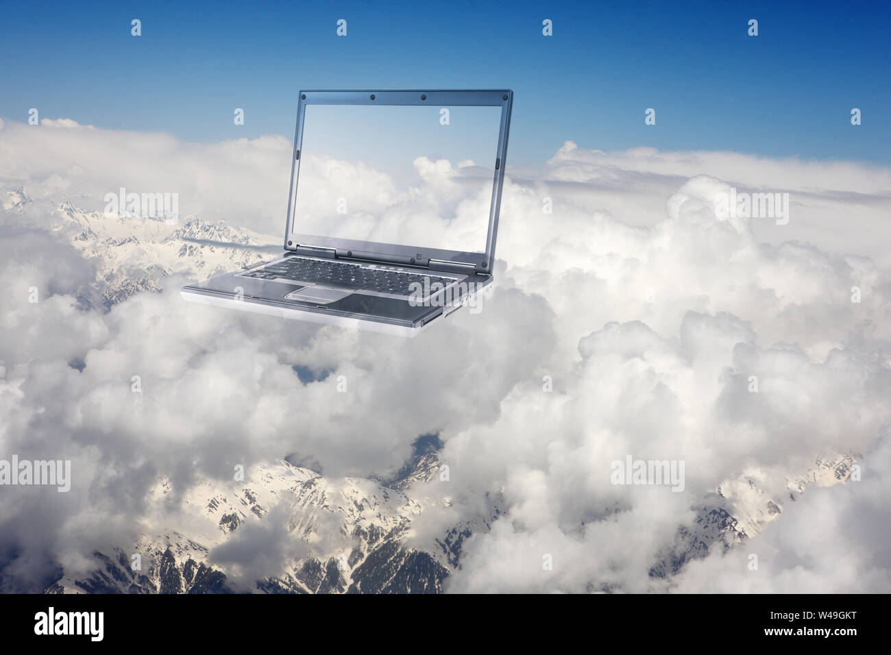 Laptop floating in clouds Stock Photo
