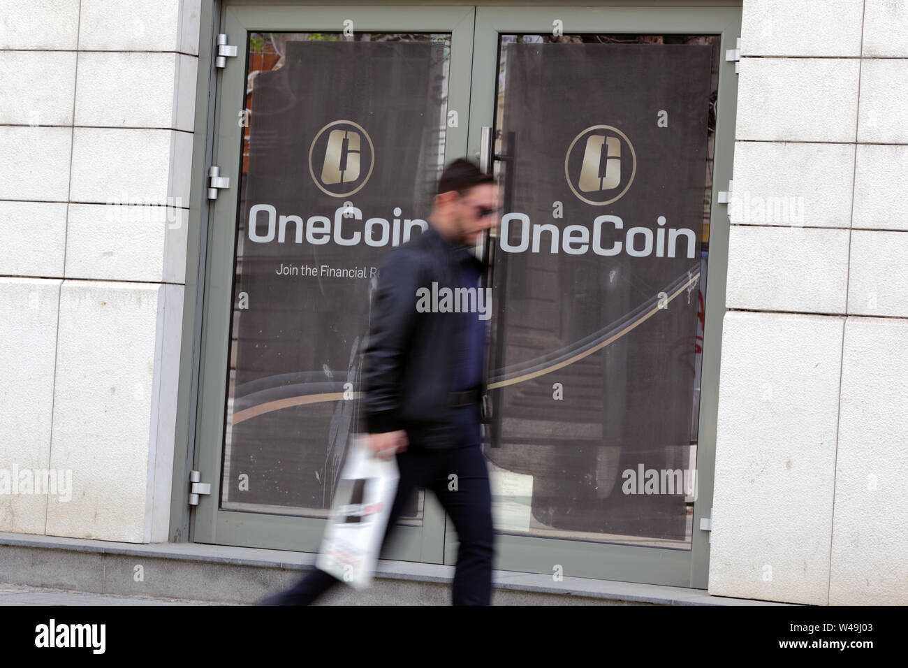 Sofia, Bulgaria - 12 May, 2019: A man passes by the office of OneCoin  cryptocurrency founded by Ruja Ignatova Stock Photo - Alamy