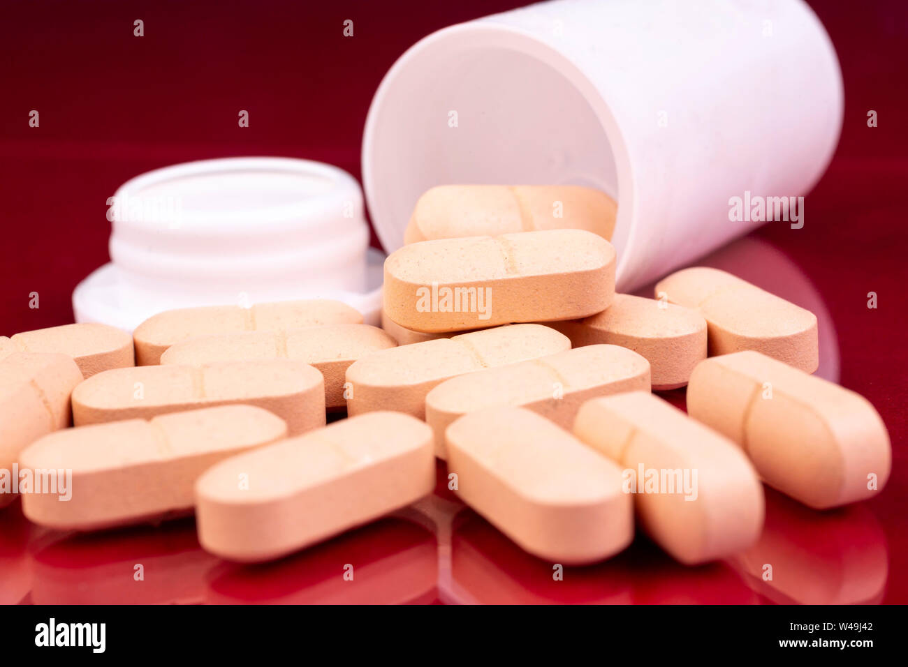 Beige pills and white plastic bottle. Global pharmaceutical industry