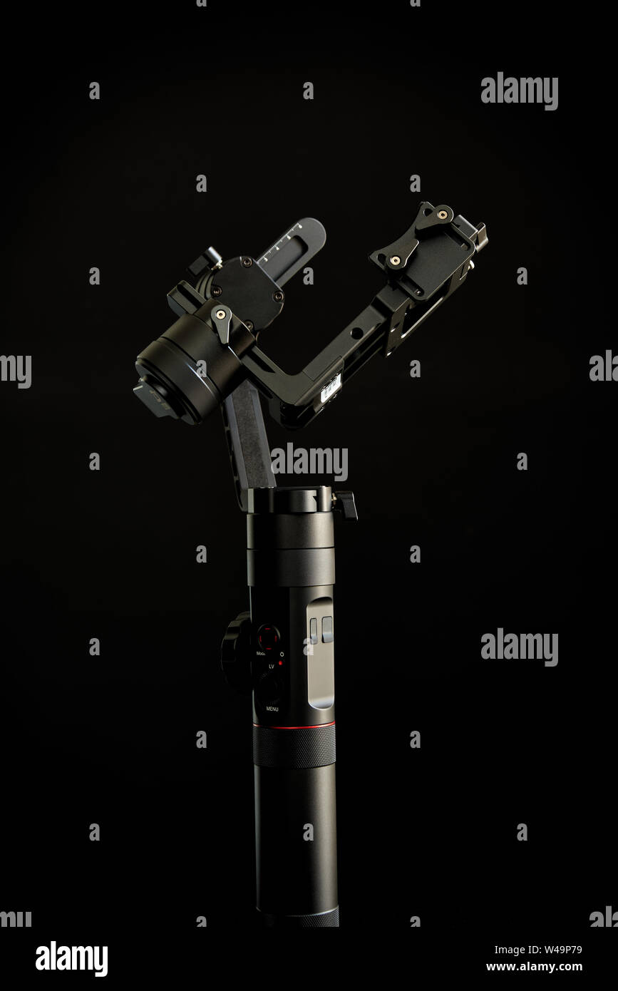 Close-up of gimbal stabilizer, with low-key lighting and a black background Stock Photo