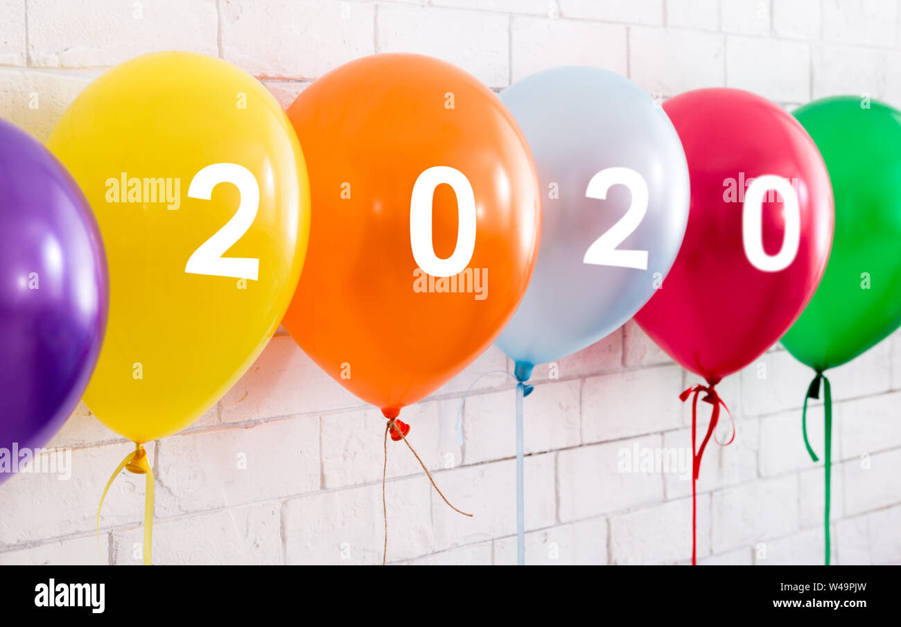 Mix of colorful balloons with ribbons and white text Stock Photo