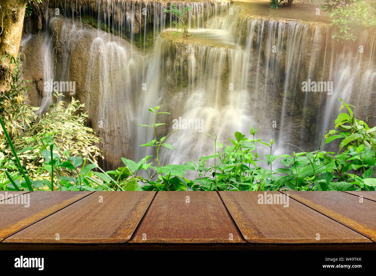 Empty wood table with beautiful scenic of the waterfall and green
