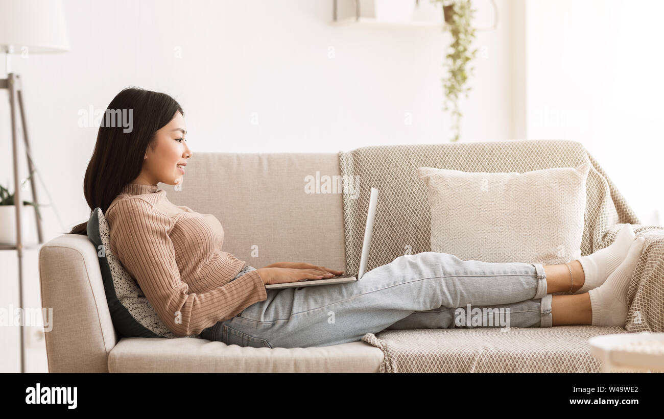 Young Blogger Typing Post on her Laptop at Home Stock Photo - Alamy