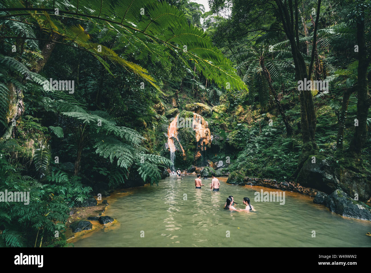 SAO MIGUEL, AZORES, PORTUGAL - JULY 29, 20189 People enjoy bath in natural thermal pools, spa of Caldeira Velha near Ribeira Grande town, Sao Miguel Stock Photo