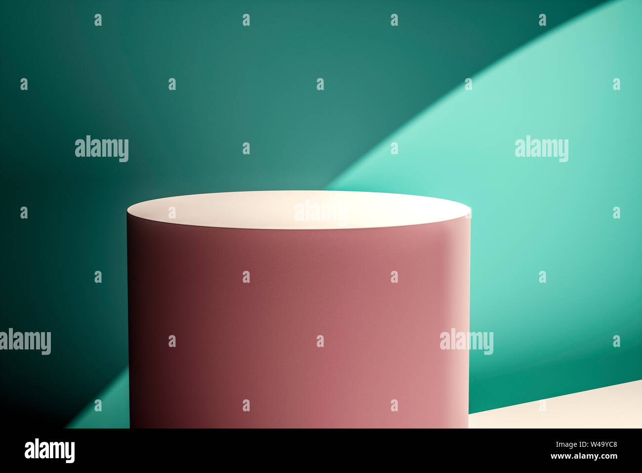 Creative layout made of pink circular product stand against a green wall in a shaft of sunlight creating a mix of perspectives and shadows for a desig Stock Photo