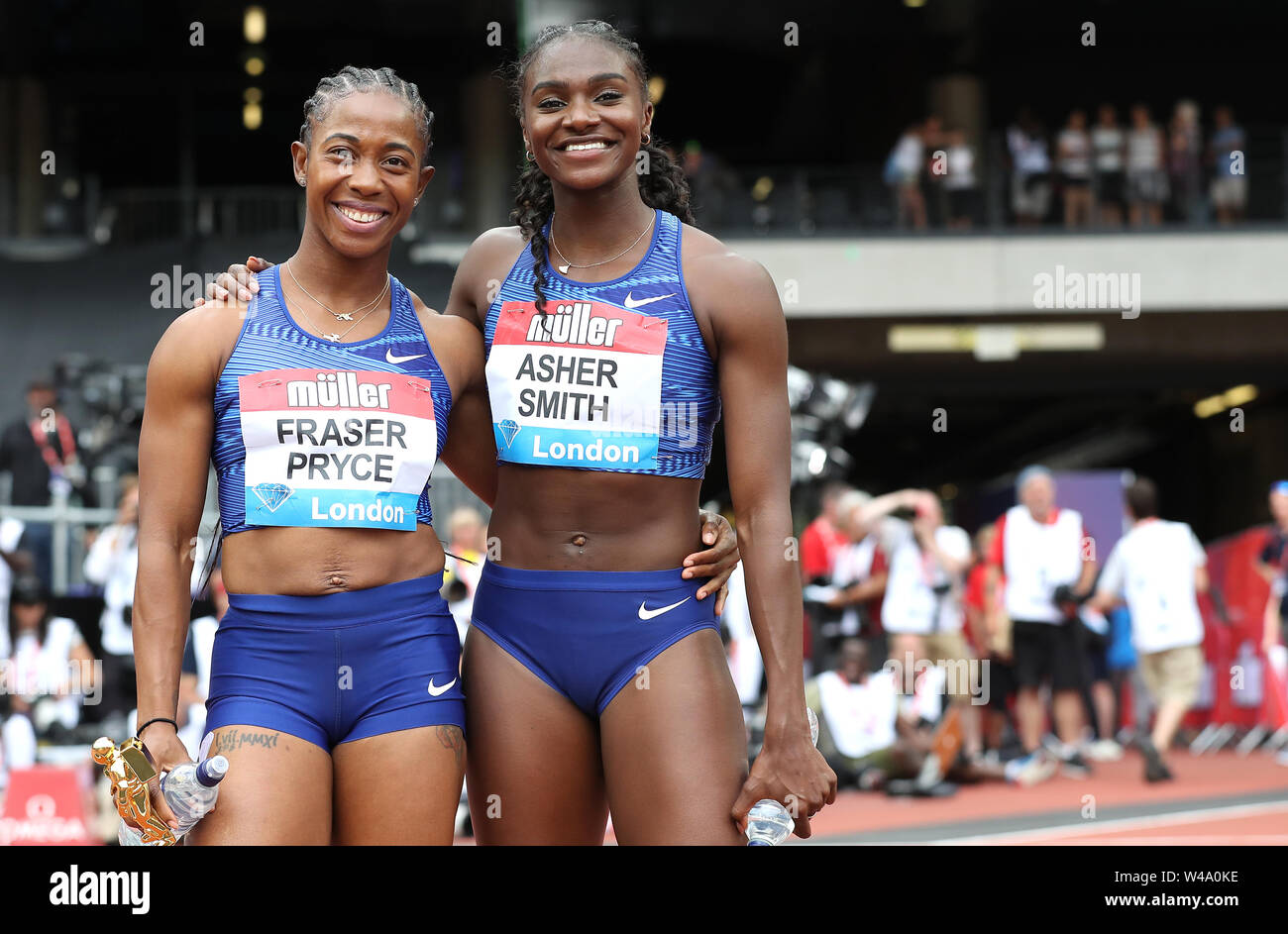 Jamaica's Shelly-Ann Fraser-Pryce and Great Britain's Dina Asher-Smith react after taking gold and silver in the Women's 100m final during day two of the IAAF London Diamond League meet at the London Stadium. Stock Photo