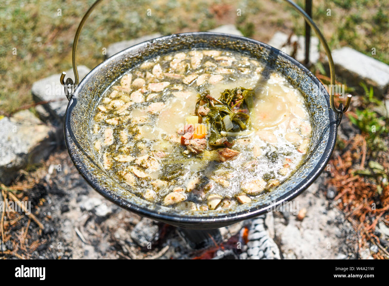 Hungarian pot over the fire bogracs during cooking the dish Stock Photo