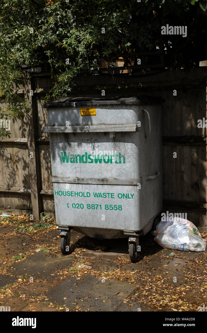 Industrial sized bin with Wandsworth, Household Waste Only in green lettering on front. Stock Photo