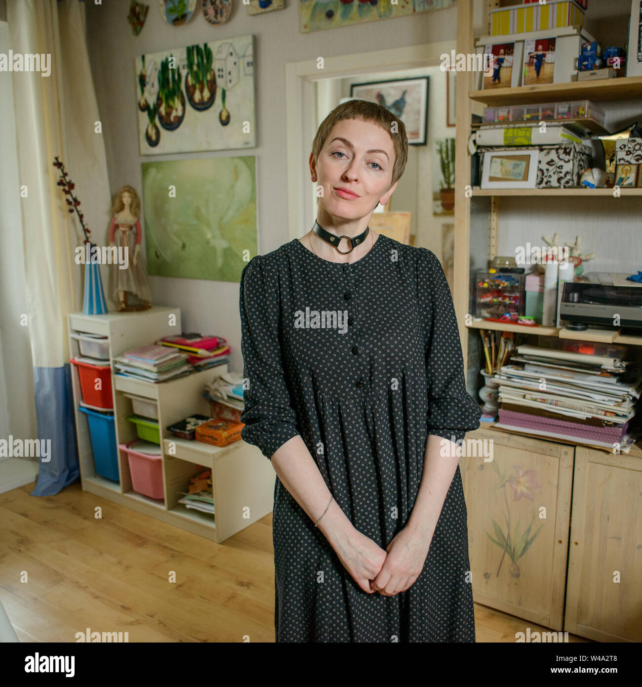 Dina Kalinkina - well-known Moscow based painter working in fugurative and stilllife genres at her living room. Stock Photo