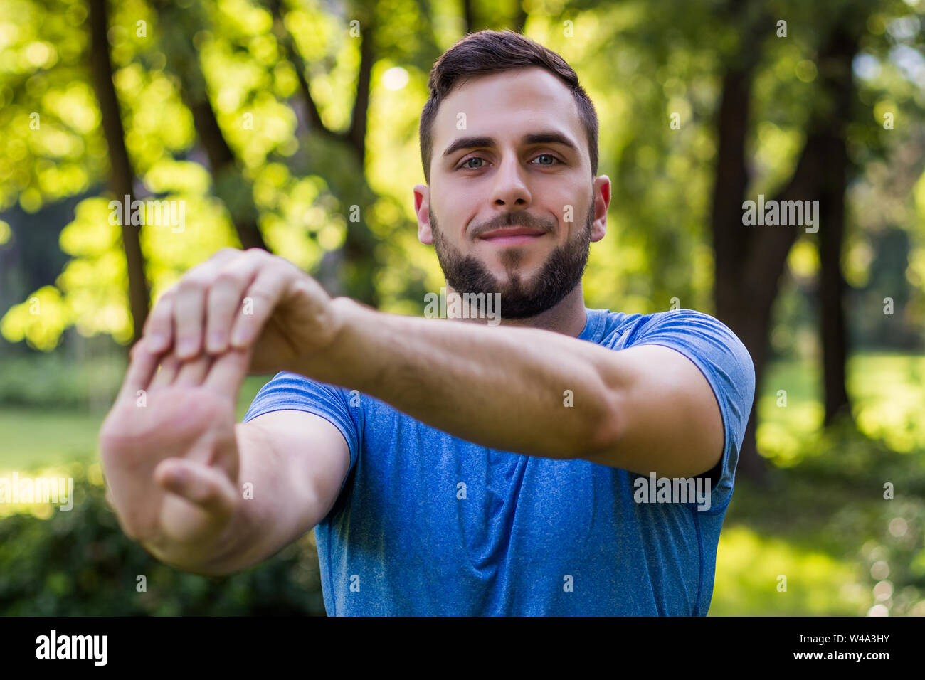 Handsome man exercising in the park. Stock Photo