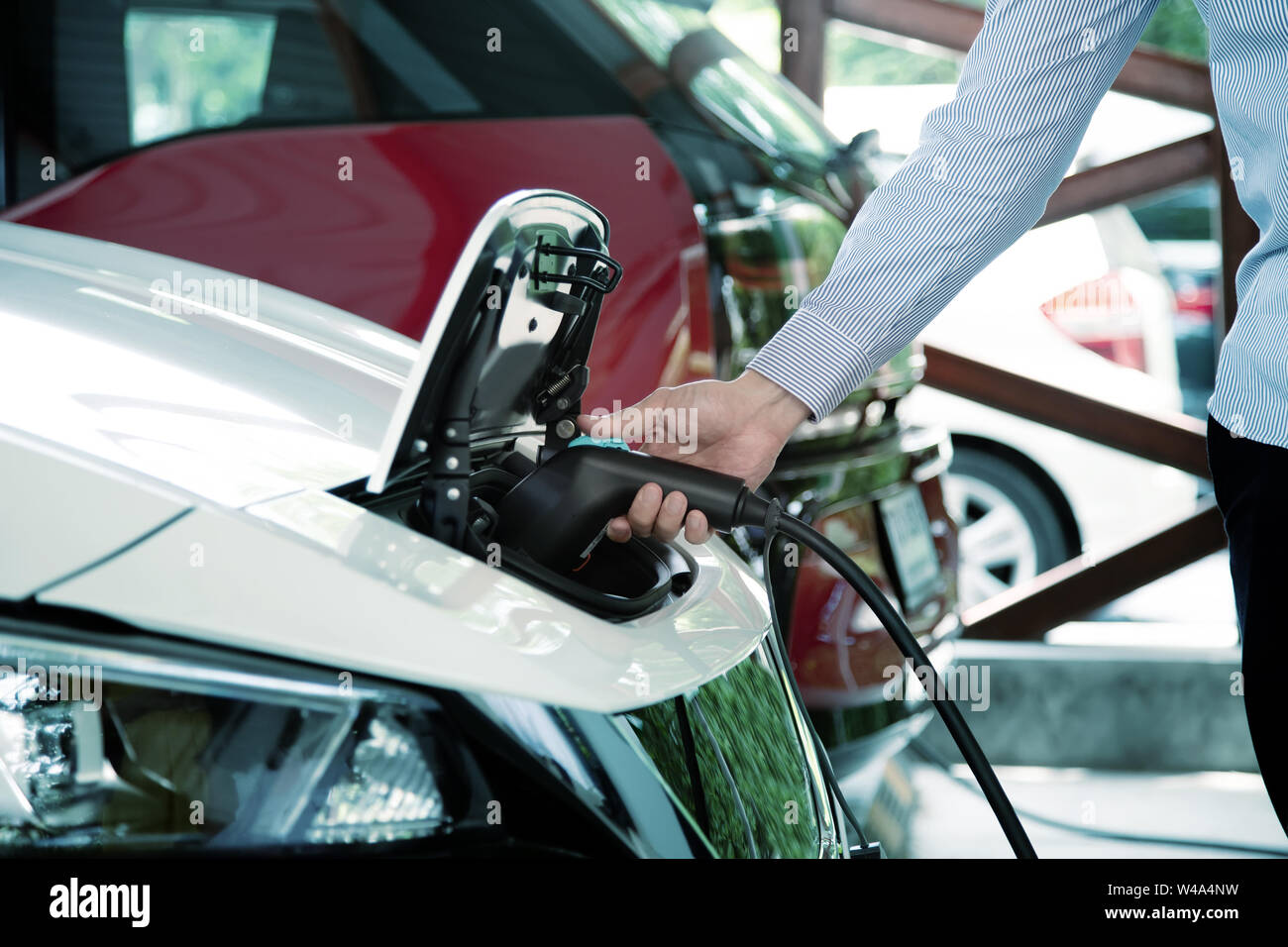 hand hold charger electric vinhicle car for power at station to technology of car Stock Photo