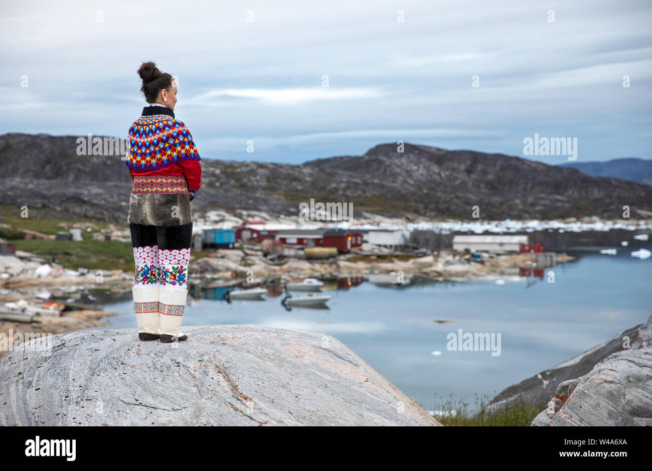 Young inuit woman in traditional clothing posing for photos in a small Greenlandish village. Stock Photo