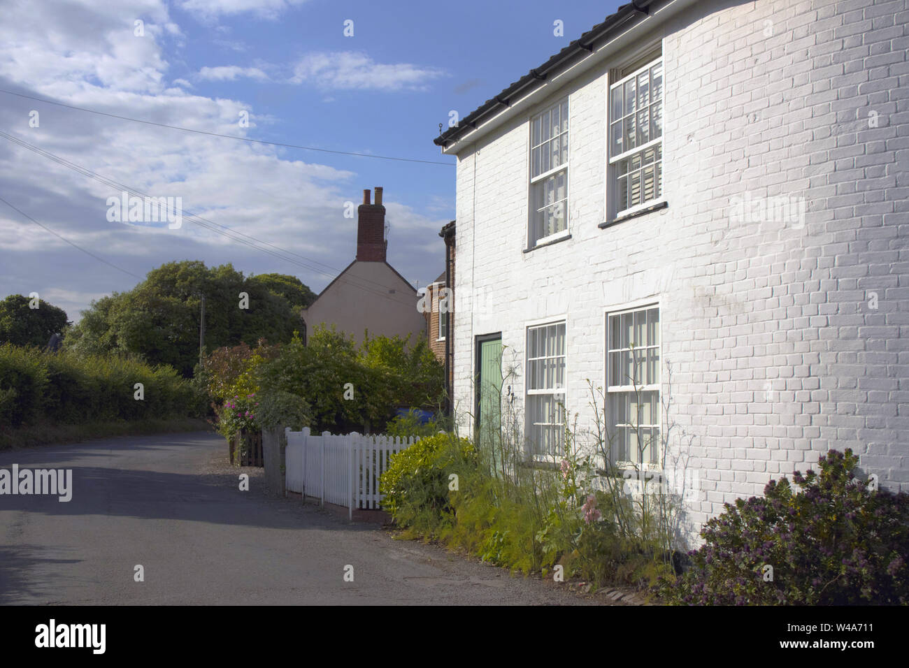 Beautiful white-painted house with a rounded corner in the village of ...