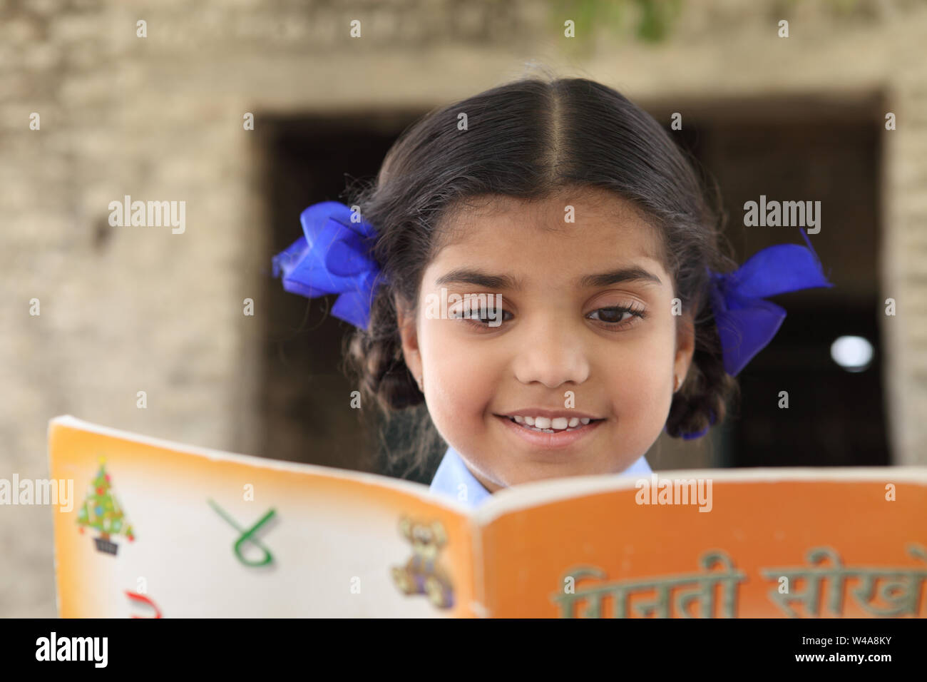 Close up of a schoolgirl reading a book Stock Photo - Alamy