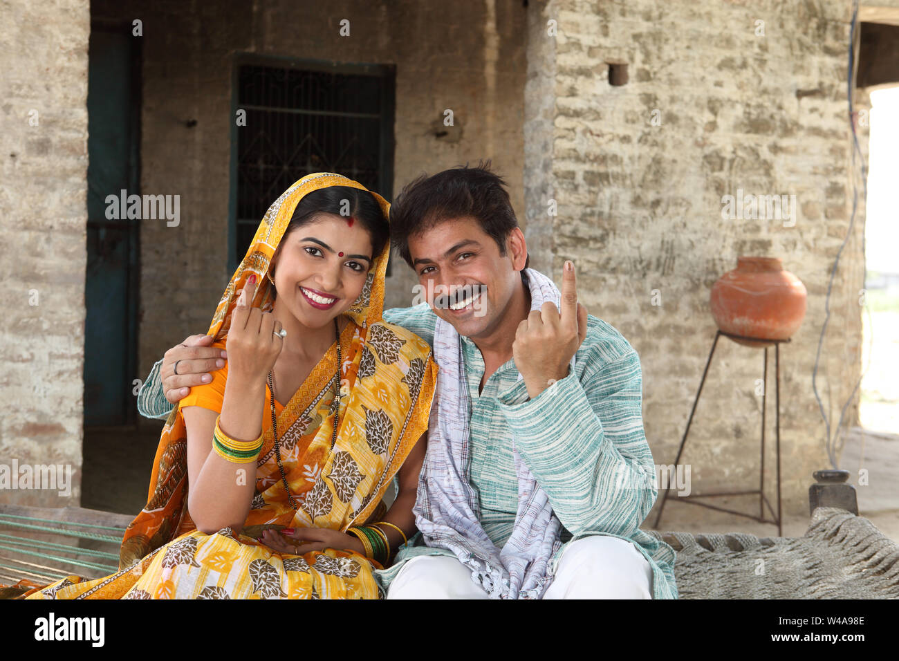 Rural couple pointing upward and smiling Stock Photo - Alamy
