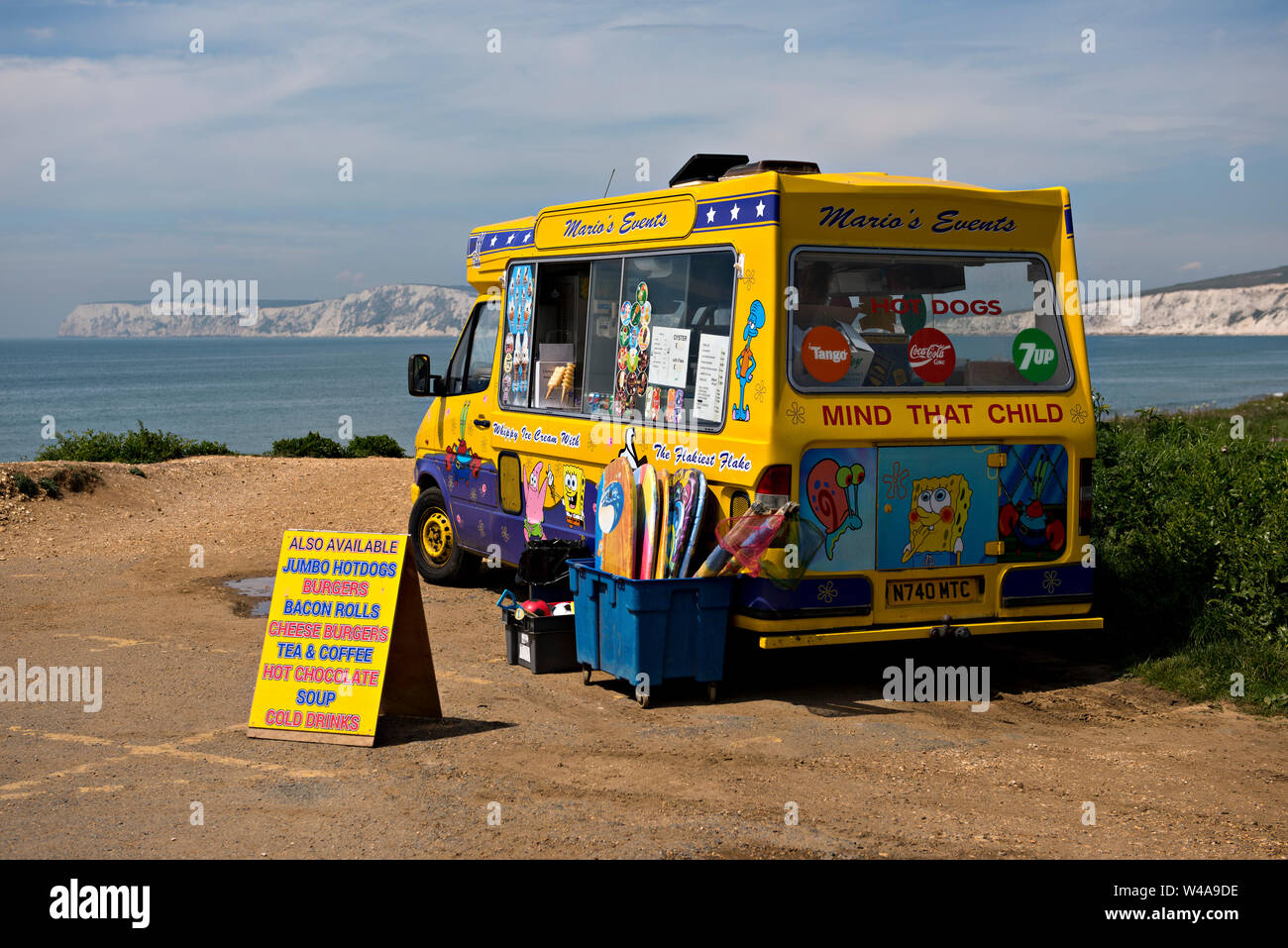 An ice cream van selling snacks and souvenirs parked in the National Trust car park at Compton Beach, Isle of Wight, UK Stock Photo