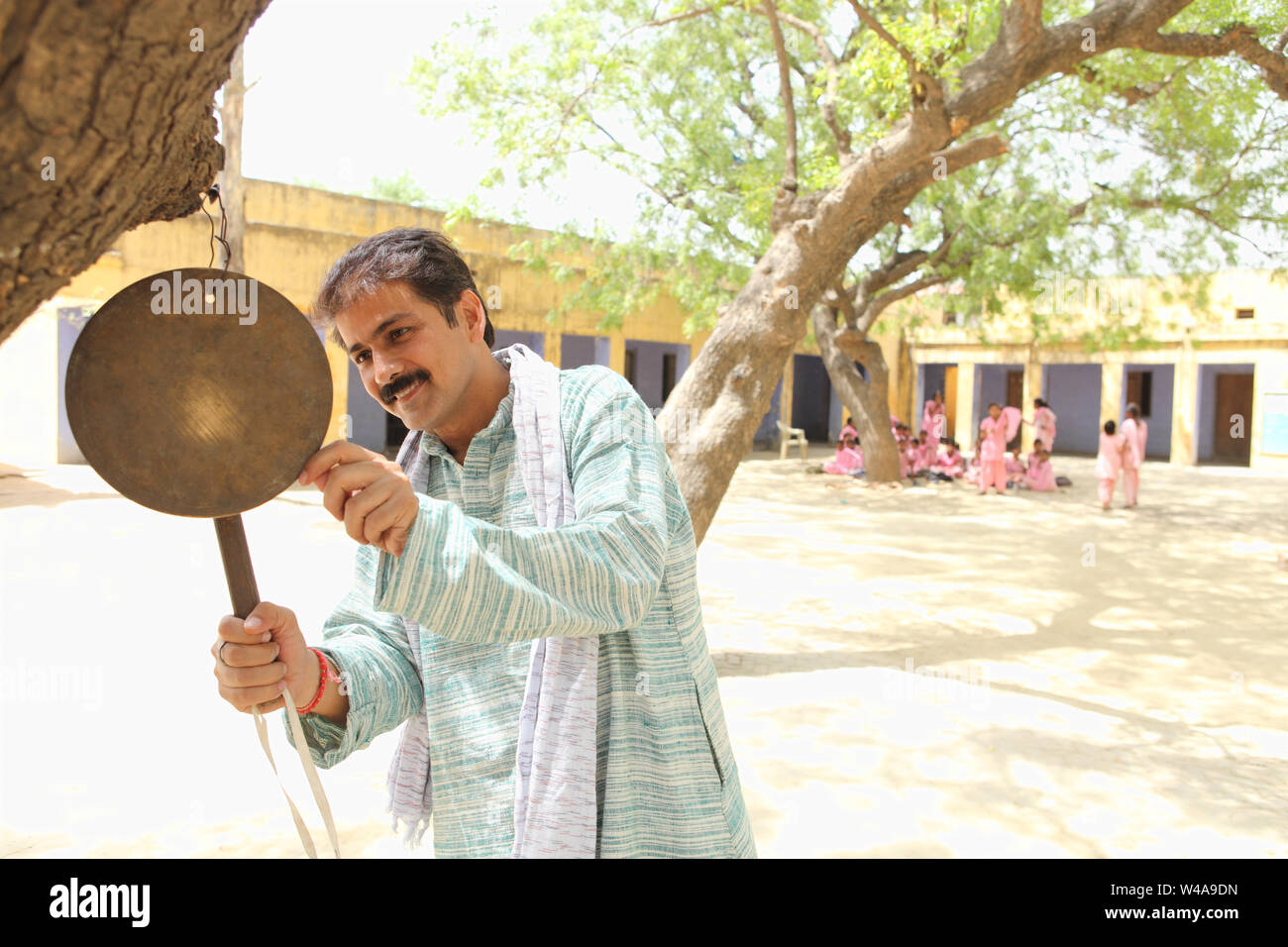 Man ringing bell in school Stock Photo Alamy