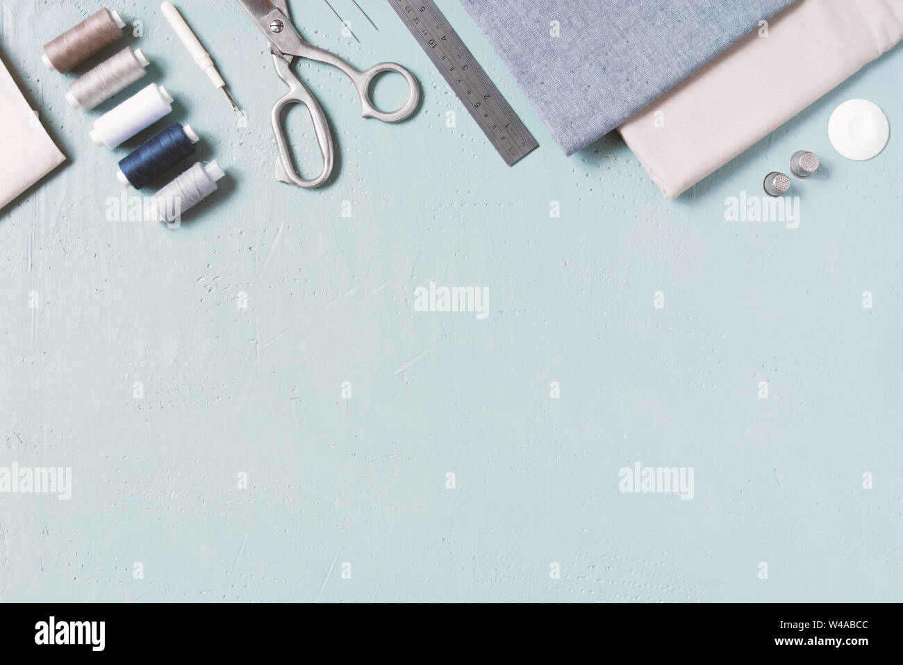 Blue textured background with sewing tools, copy space Stock Photo
