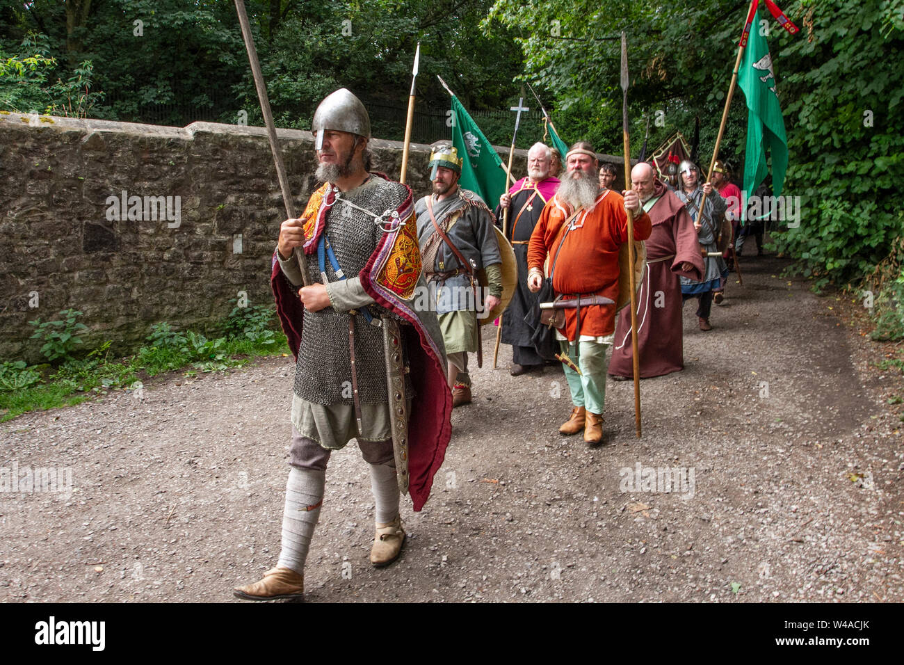 Viking age, clothing costumes & weapons at Heysham, Lancashire.  July, 2019. Battle flags fly at Morecambe Bay as 70 historical heritage warrior re-enactors gather at a Medieval Living History Encampment to demonstrate era weapons, and do battle on the village green. The Gods Idin, Thor and Frey were celebrated together with other Vikings mythology. Stock Photo