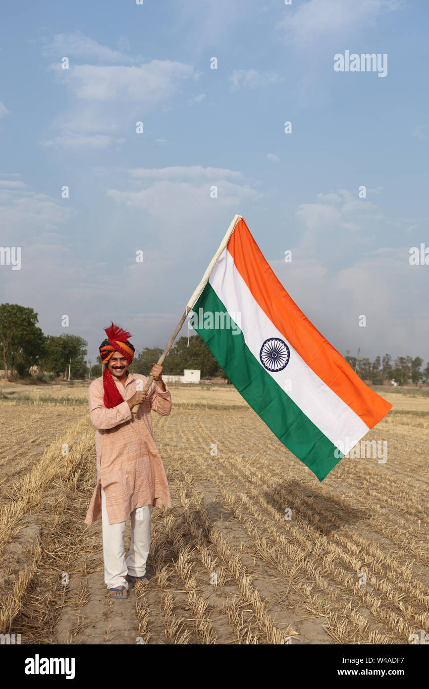 Indian farmer holding indian flag hi-res stock photography and images