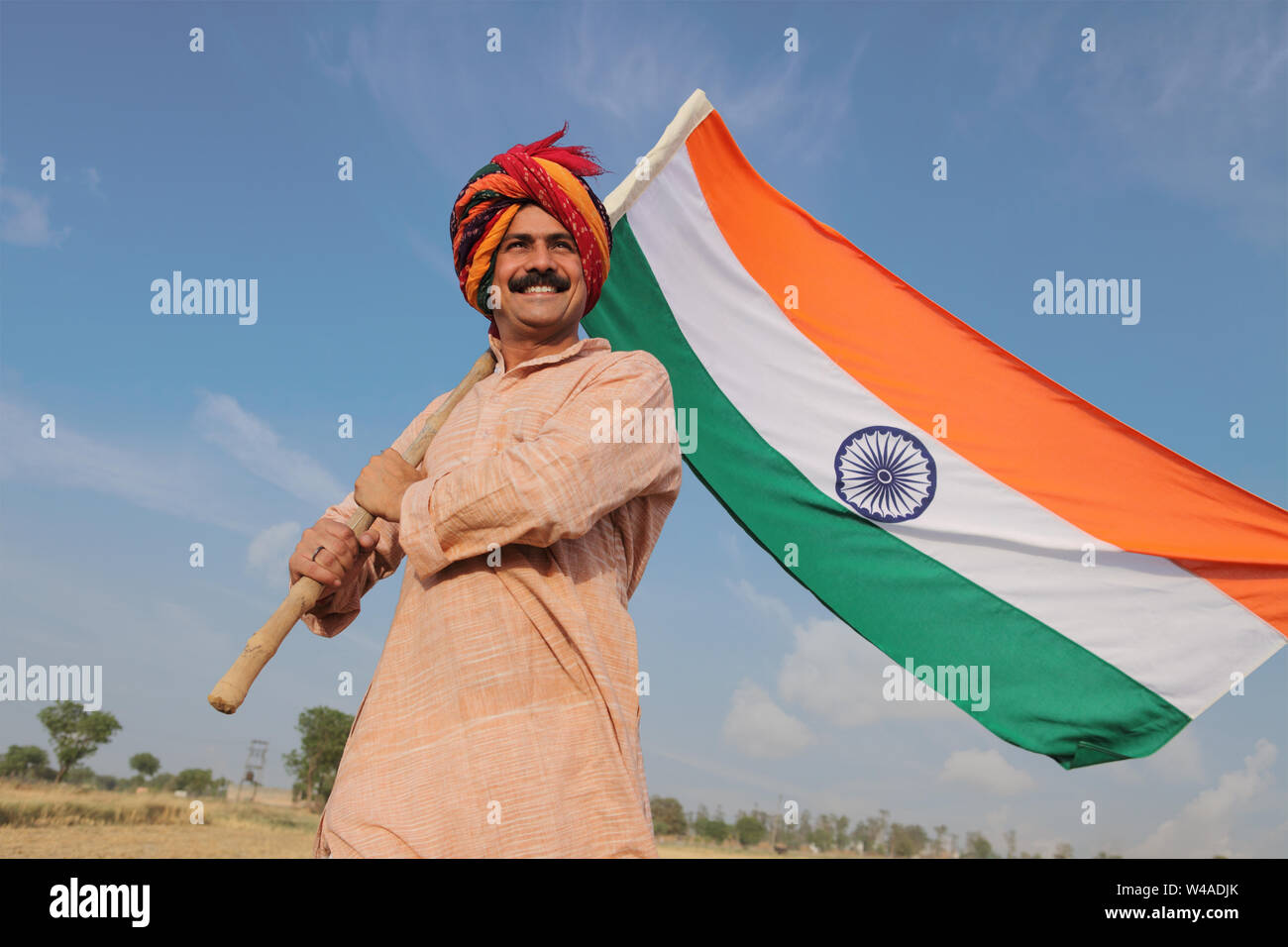 Farmer holding an Indian flag in a field Stock Photo - Alamy