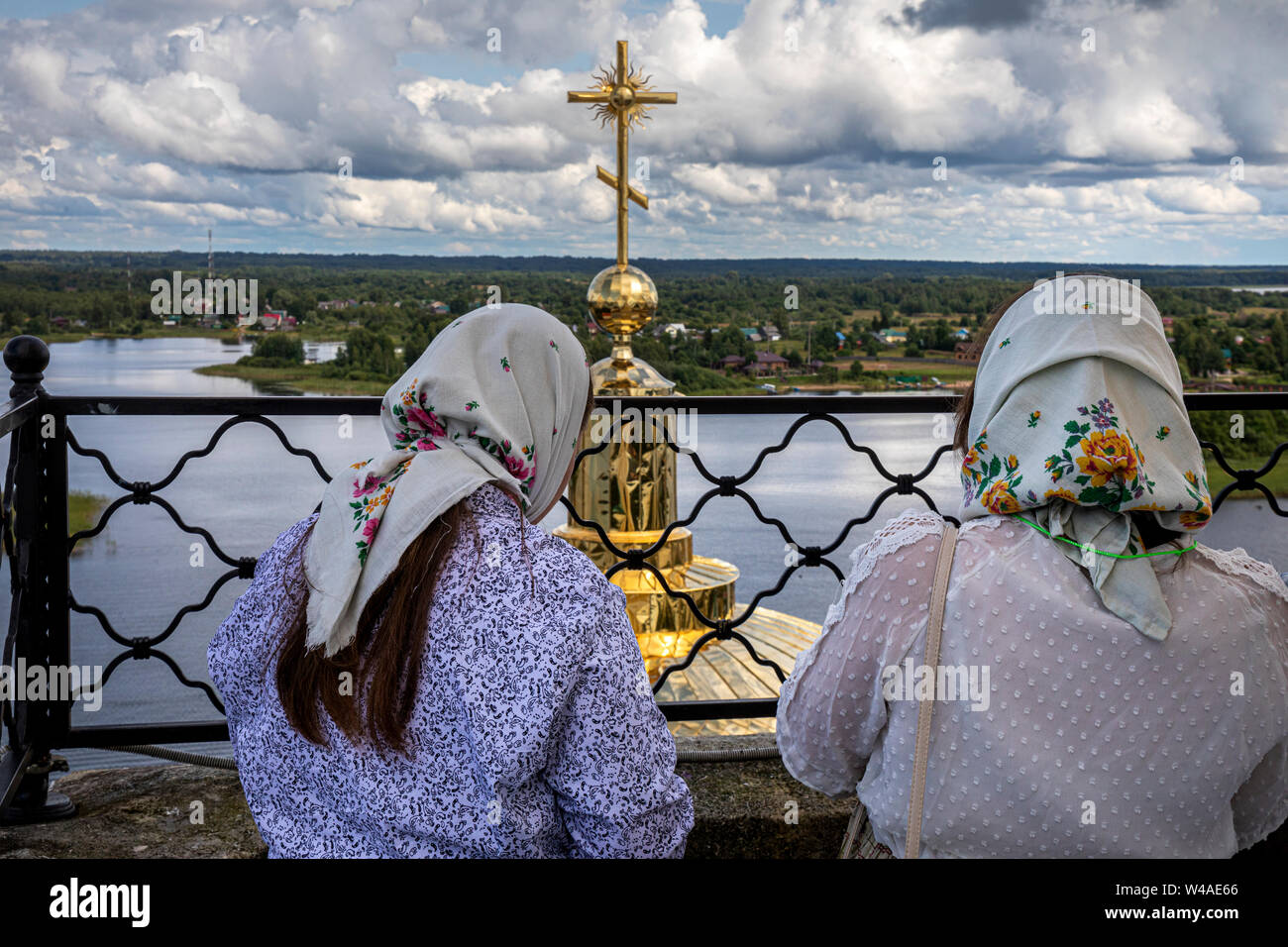 Orthodox women look at orthodox temples of  Nilov Monastery on Stolobny Island in Lake Seliger, Tver region, Russia Stock Photo