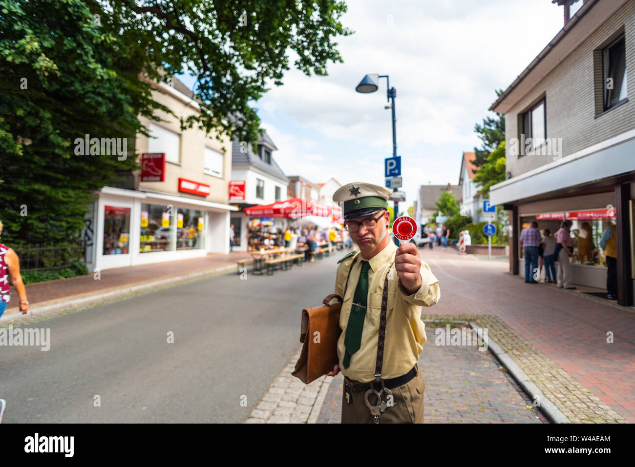 Hude, Germany, July, 21 2019: the day after the italian night in the municipality of hude lower saxony. A disguised comedian in a police costume with Stock Photo