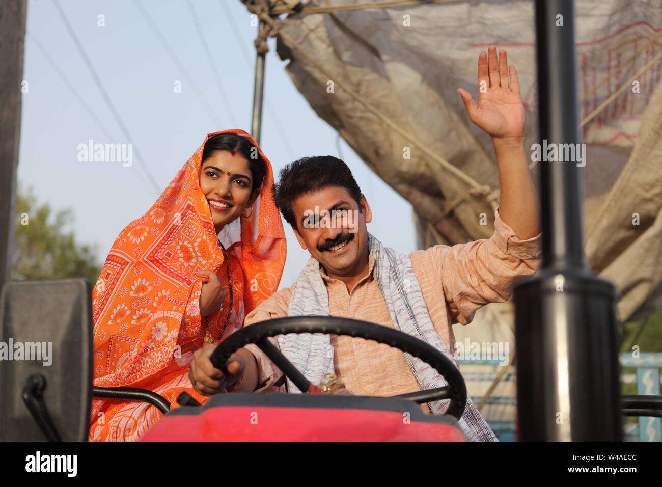 Indian farmer driving a tractor with his wife sitting beside him Stock ...