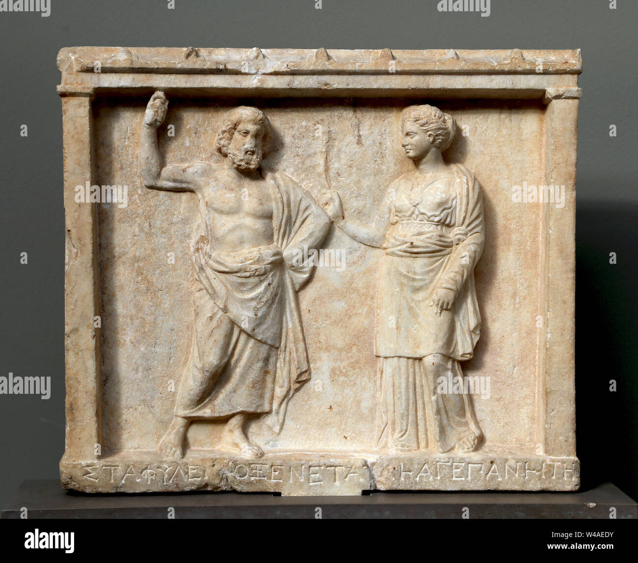 Offering to Staphylos, the grape god. Thrace. Depicting Athena and Staphylos. 4th century BC. Marble. Carlsberg Glyptotek. Stock Photo