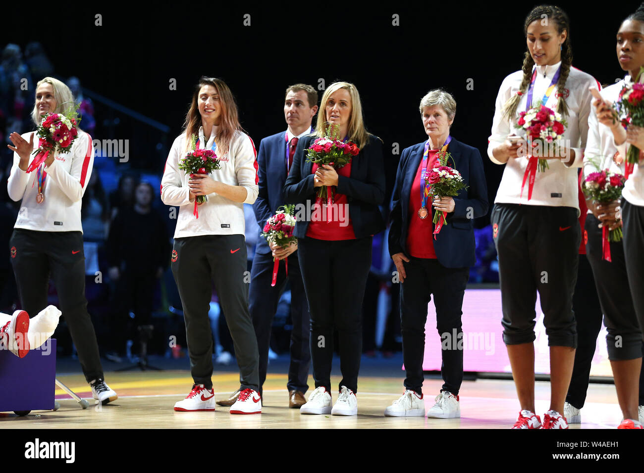 England coach Tracey Neville (centre) with a bronze medal after ...