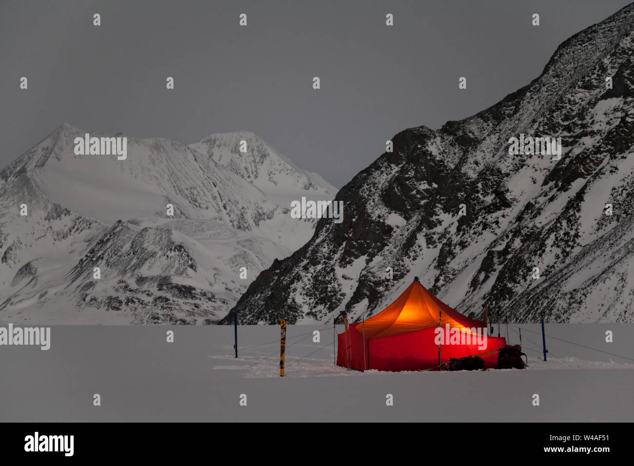 Winter night landscape with bright tourist tent of ski tour alpinists. Altay hight mountains. Siberia. Russia. Stock Photo
