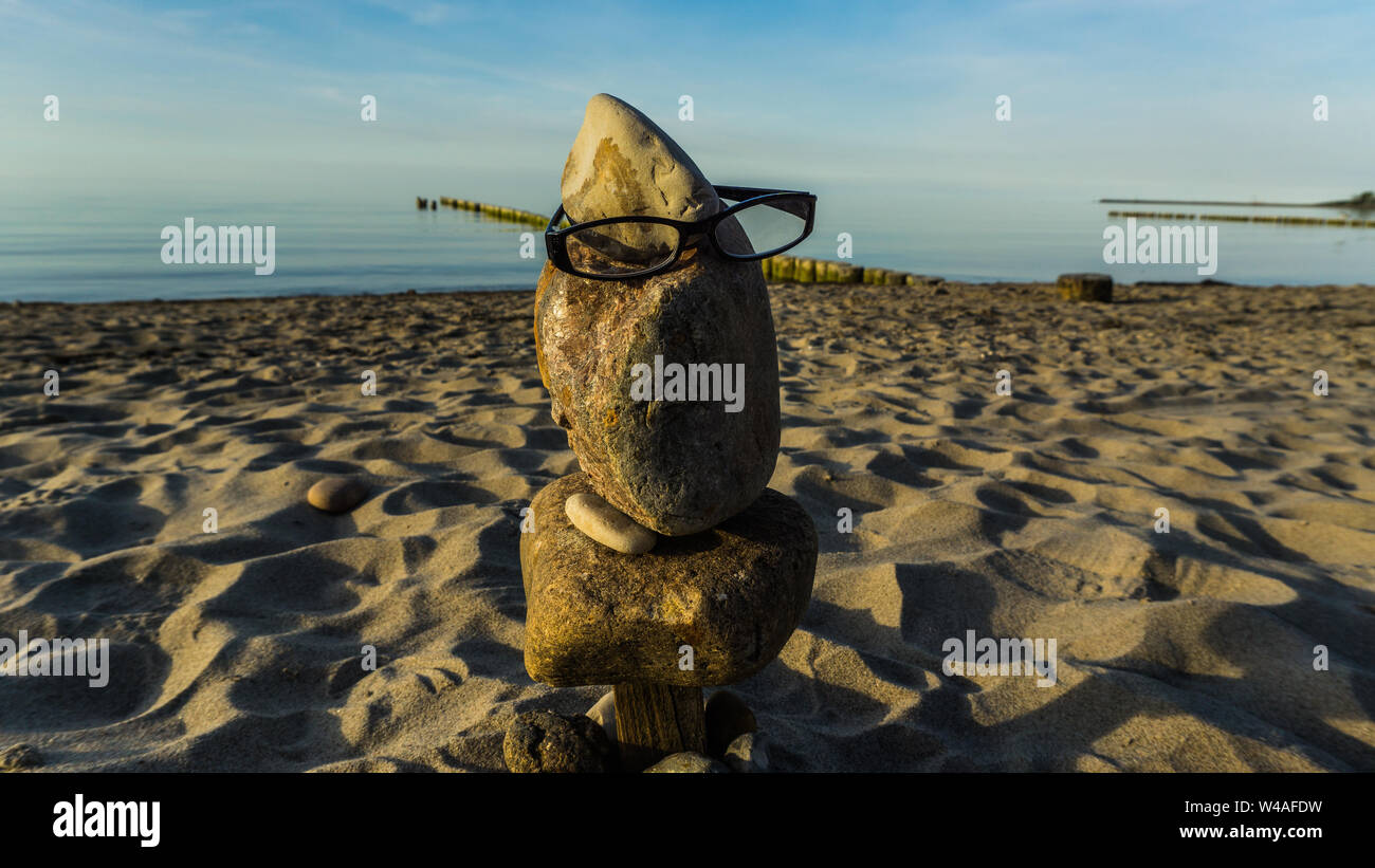 stone face with glasses Stock Photo
