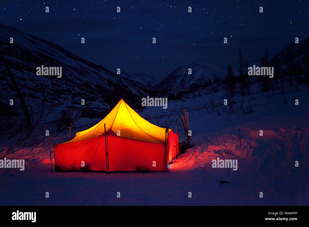 Winter night landscape with bright tourist tent of ski tour alpinists. Altay hight mountains. Siberia. Russia. Stock Photo