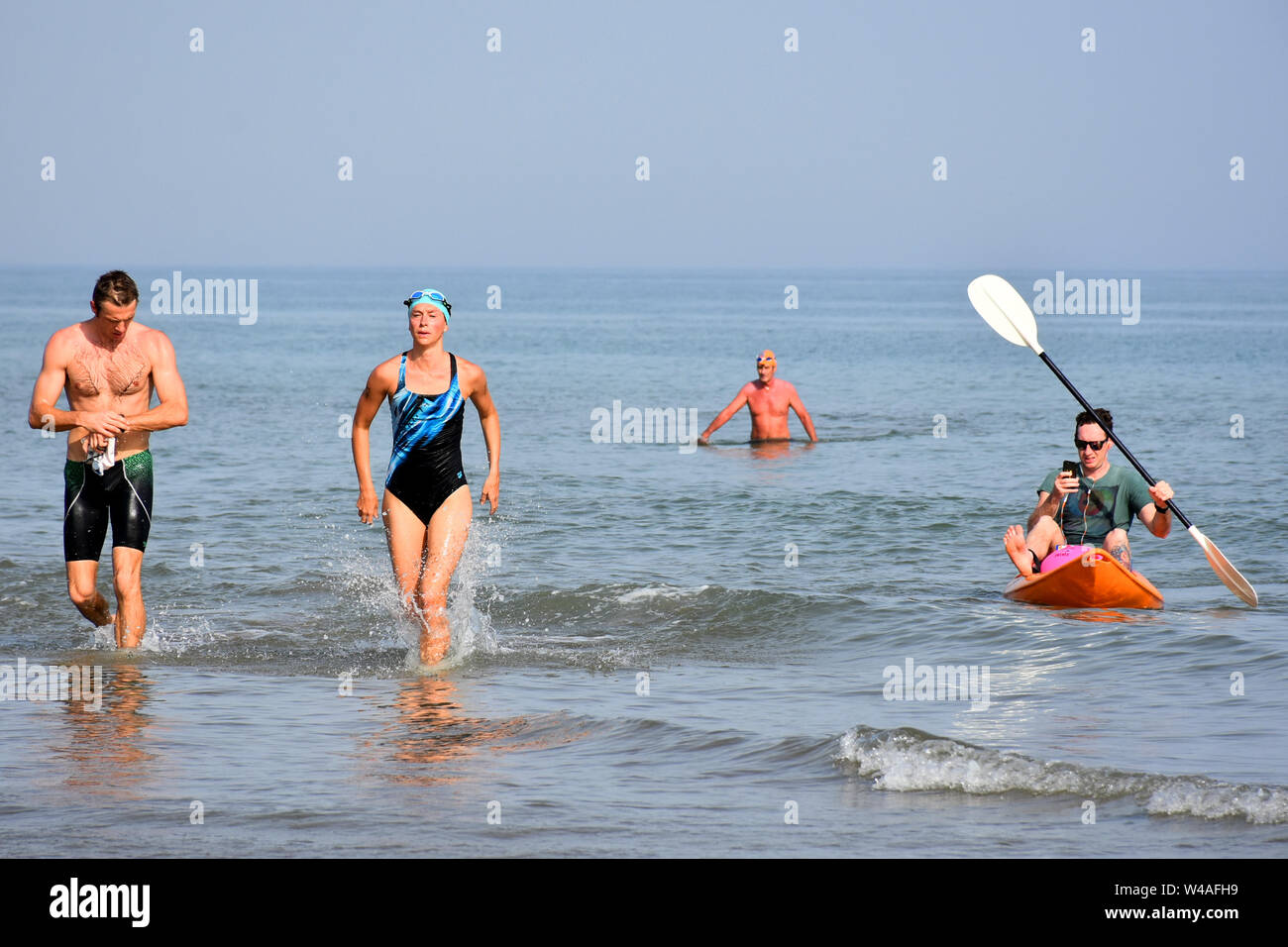 Many people swimming and boating in the seawater in summer outdoor activities. Stock Photo