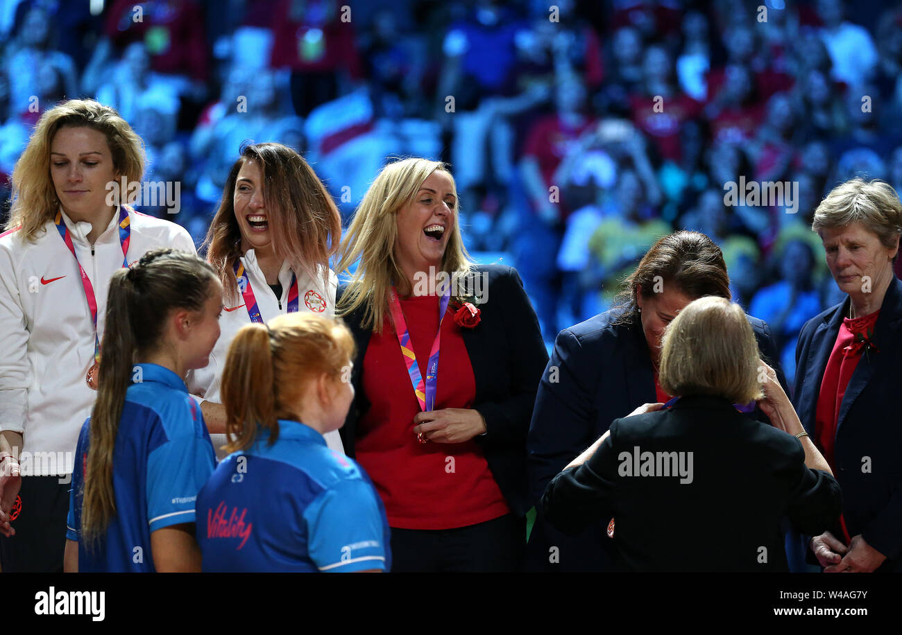 England coach Tracey Neville (centre) is presented with a bronze medal ...