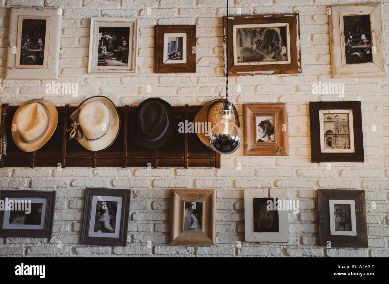 Picture frames hanging on the wall with hats in a grid formation, vintage style Stock Photo
