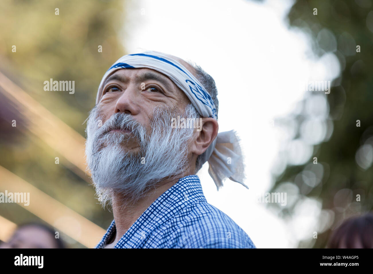 A mature man in traditional dress performs a Bon dance at the 87th annual Bon Odori Festival in Seattle, Washington on July 20, 2019. The lively summer festival features traditional music and folk dance to welcome the spirits of the dead and celebrate the lives of ancestors. Stock Photo