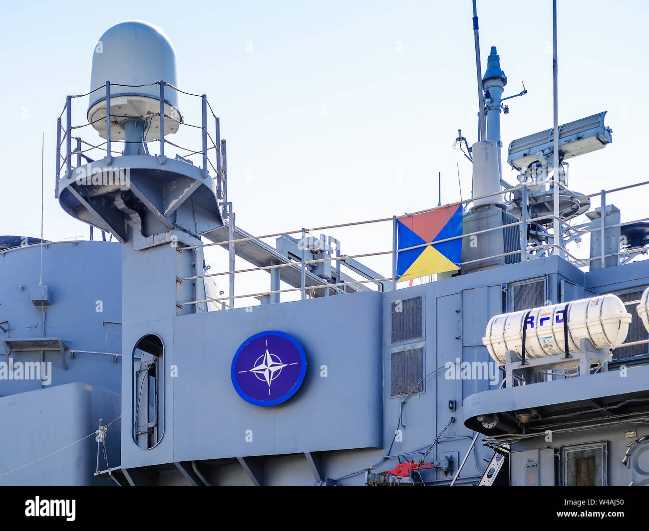 Varna, Bulgaria, July 20, 2019. The blue Nato logo on a side of a large gray modern warship with radars and weapons. Naval exercises. Stock Photo