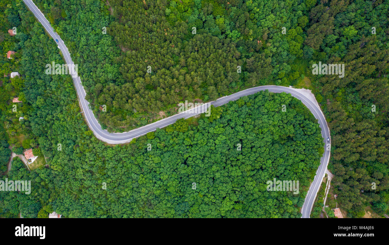 Aerial view of winding road trough the dense woods on the high mountain in Bulgaria. Stock Photo
