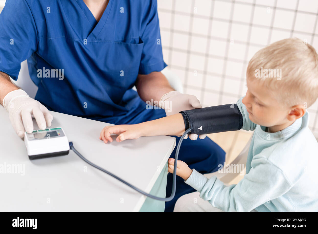 Doctor measuring blood pressure of a little boy. Diagnostic, healthcare, medical service. Doctor pediatrician concept Stock Photo