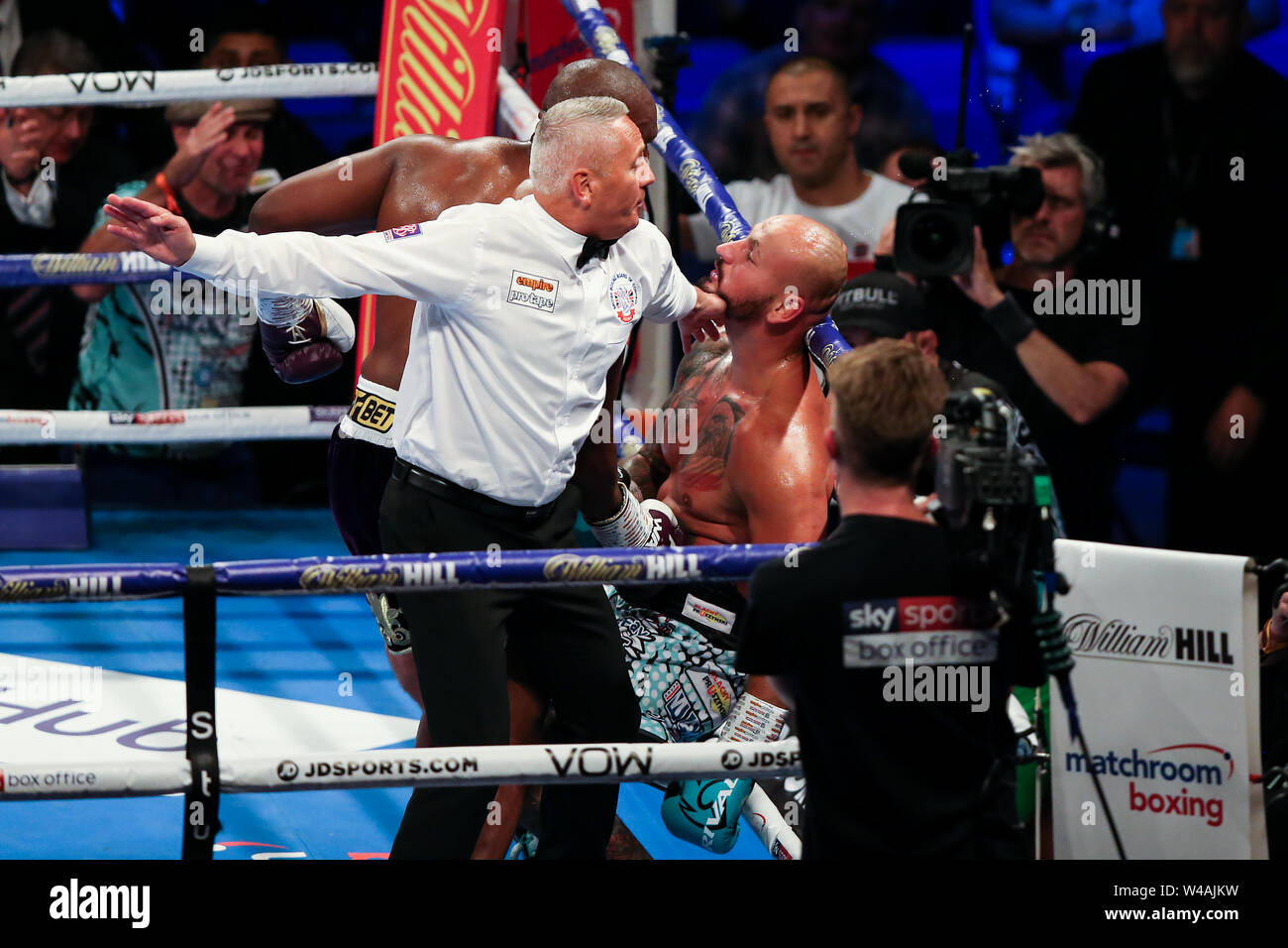 LONDON, ENGLAND - JULY 20: The referee jumps in as Dereck Chisora knocks out Artur Szpilka during the Heavyweight contest during the Matchroom Boxing Stock Photo