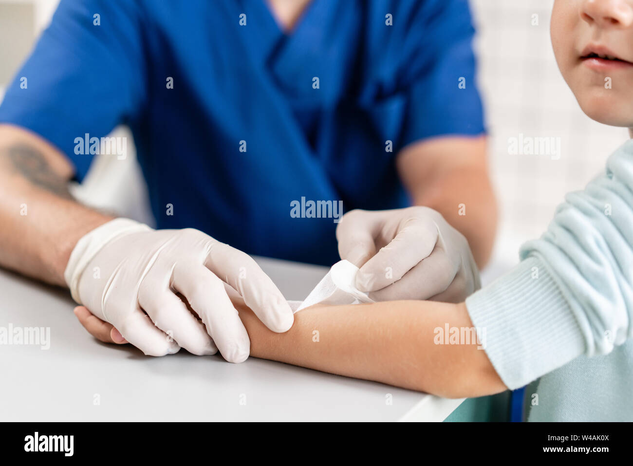 medical patch. Doctor bandaged a boy hand with trauma in his arm. Elastic bandaged around his hand Stock Photo