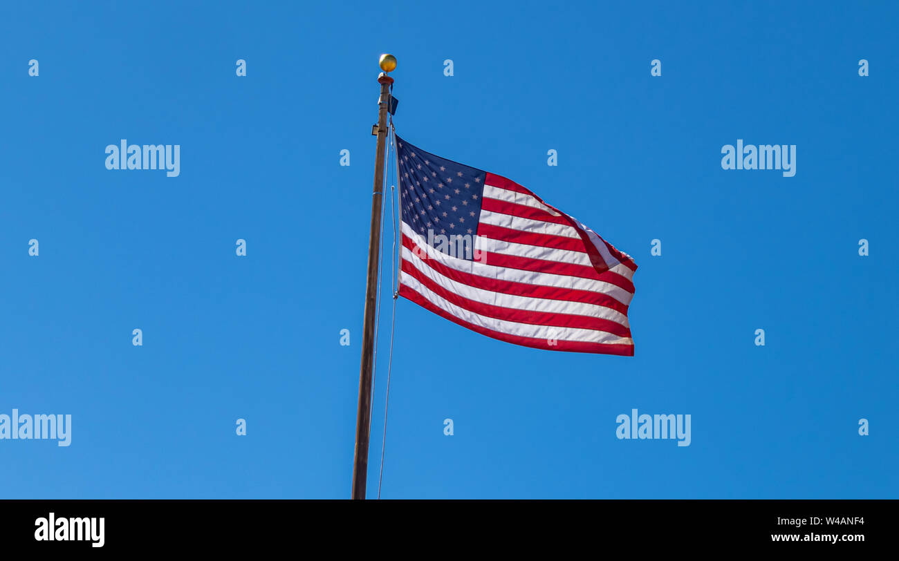 USA symbol. United States of America flag on a pole waving isolated ...