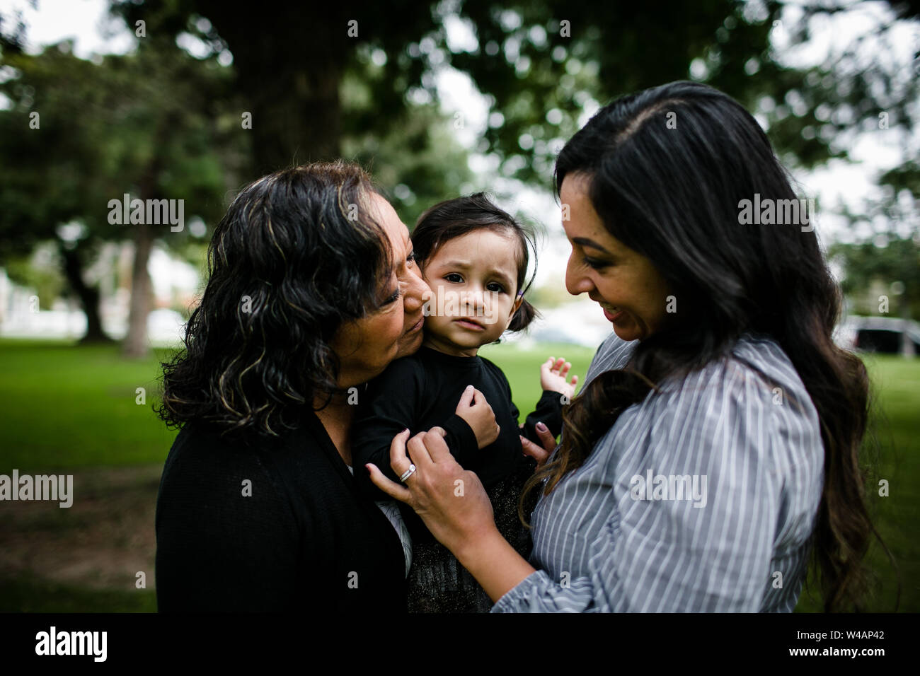 Grandmother, mother & daughter in park Stock Photo