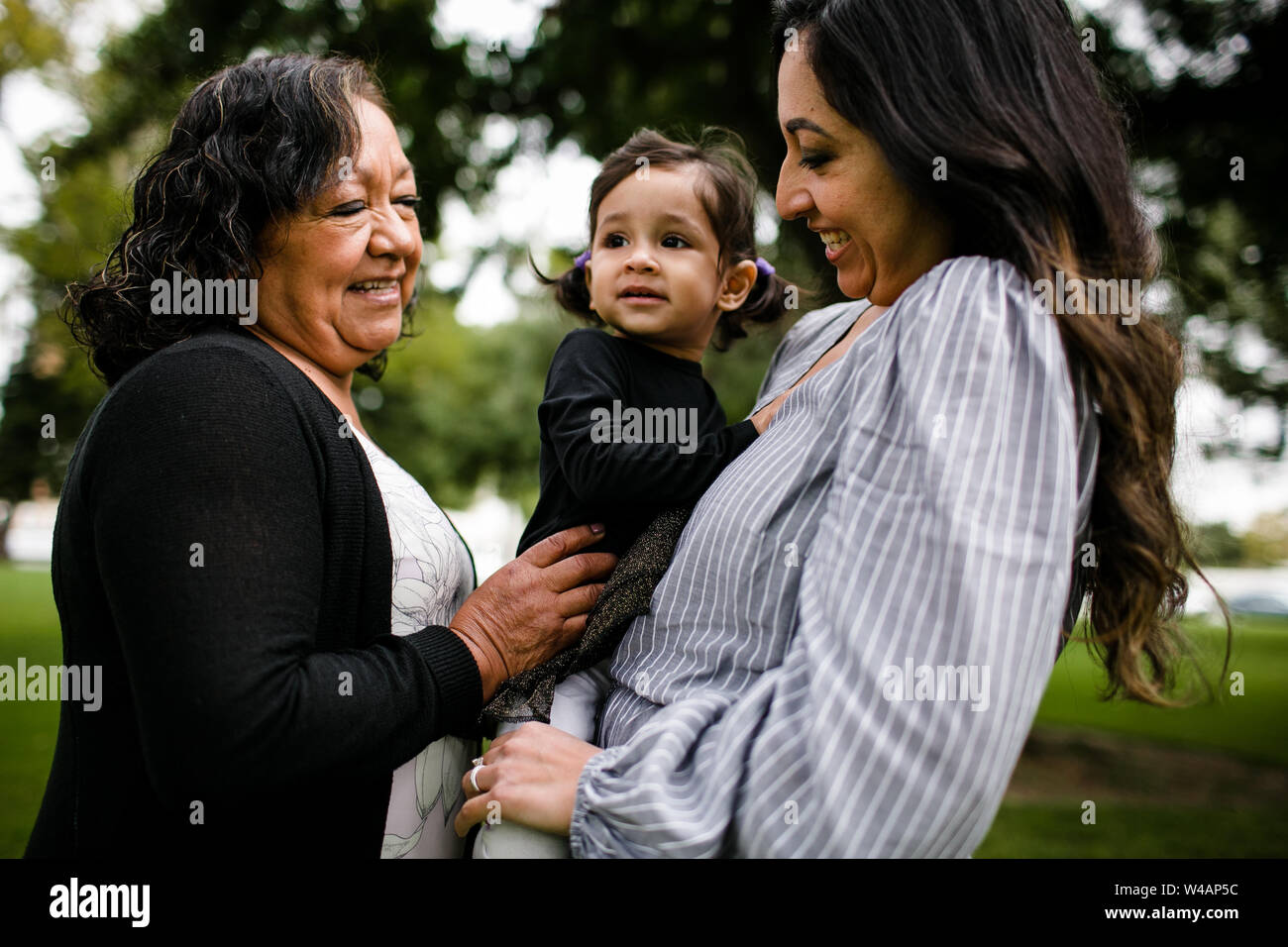 Grandmother, mother & daughter hugging Stock Photo