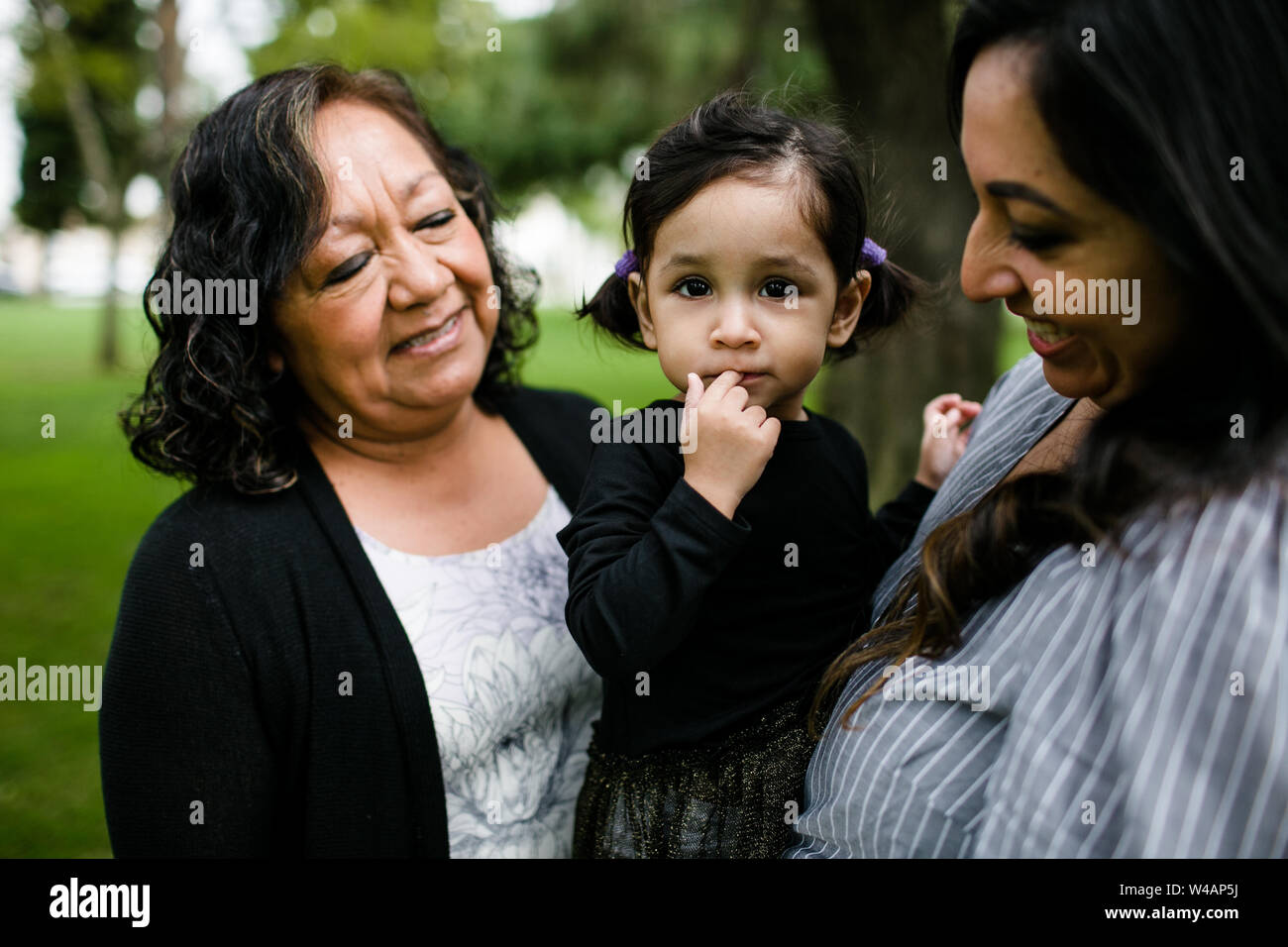 Grandmother, mother & daughter hugging Stock Photo