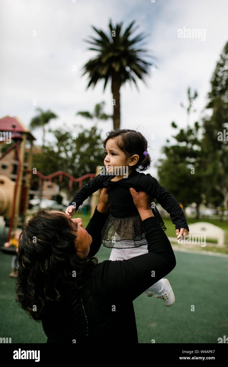 Grandmother holding granddaughter at park Stock Photo