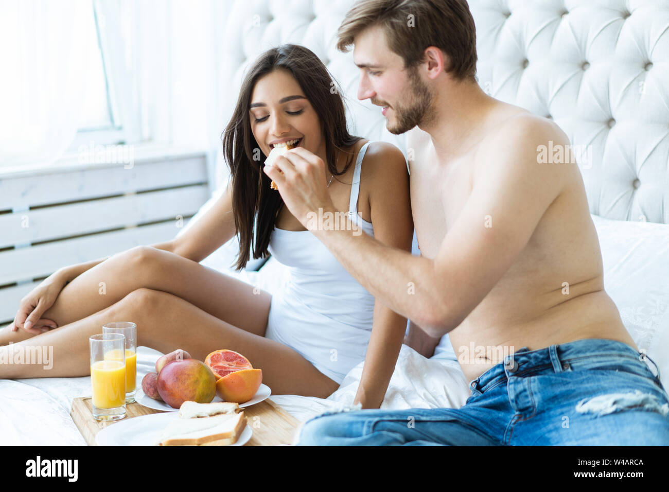 Good morning! Healthy breakfast in bed. Young beautiful love ...