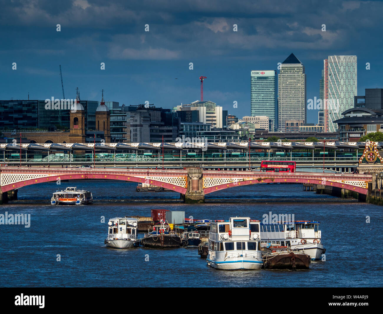 Canary Wharf London against dark skies. Canary Wharf view from Central London with Blackfriars Bridge in the foreground Stock Photo